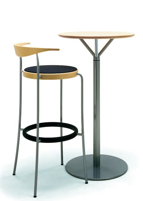La table et les tabourets de bar «Partout Bar» de Magnus Olesen se distinguent par leur design élégant. Disponible avec ou sans dossier, la chaise possède un repose-pied intégré et une assise rembourrée ou non. Avec son pied central fin, la table est